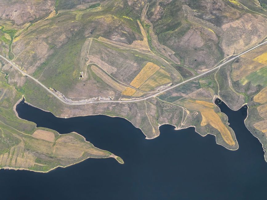 Vista panorámica de la orilla de un embalse con zona de acceso para pesca